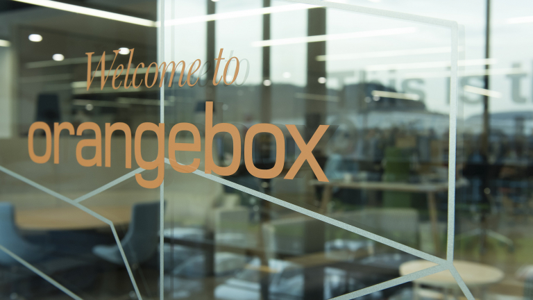 Close up of Orangebox showroom internal glass door vinyl graphics